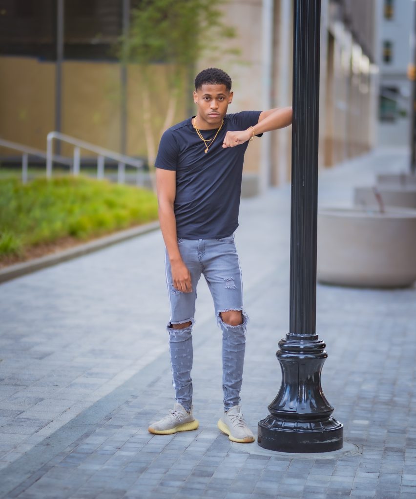 Trendsetting style with Adidas Yeezy Boost 350 V2 Sneakers, Tyler Jurelle is photographed by Aaron Robinson.