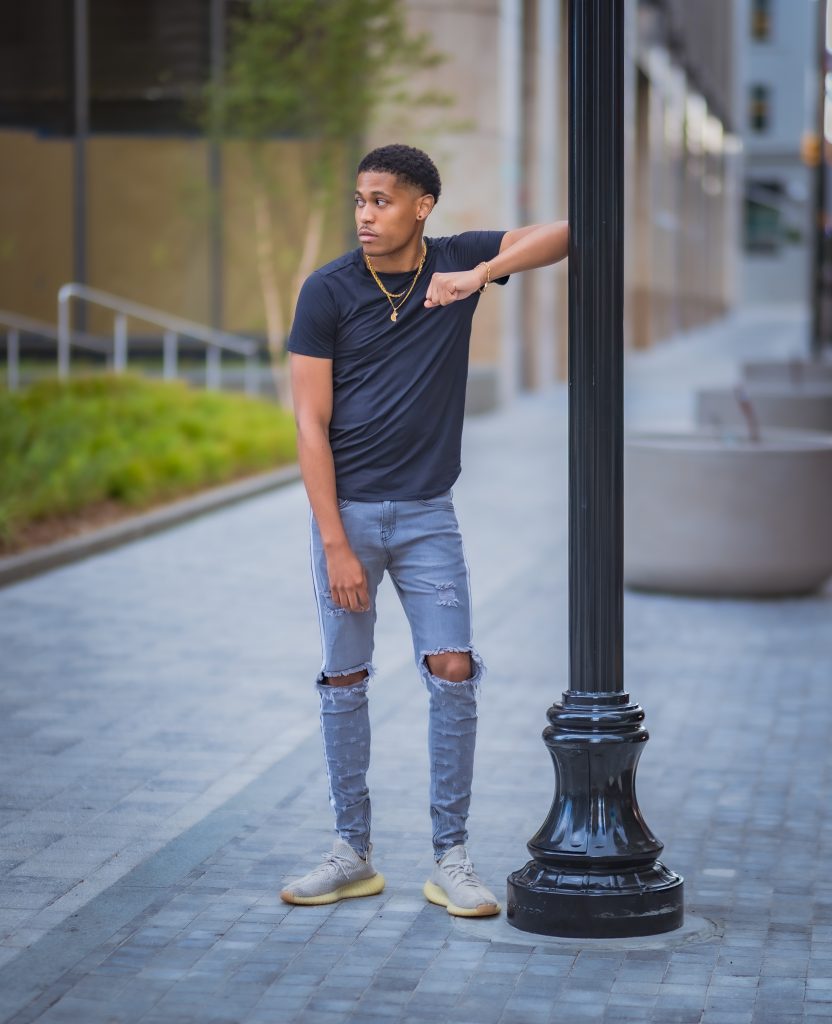 Sporty and stylish with Adidas Yeezy Boost 350 V2 Sneakers and Craftd London jewelry, Tyler Jurelle is photographed by Aaron Robinson.