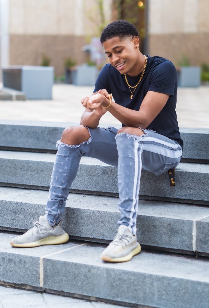Contemporary look featuring PRSTGE double stripe track jeans and Craftd London gold jewelry, photographed by Aaron Robinson.