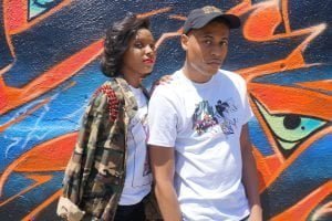 Tyler Jurelle and Nyeisha model Royal One Soul streetwear, highlighting complementary urban style.