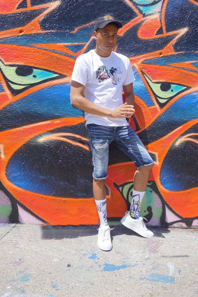 Tyler Jurelle showcases Royal Soul streetwear while standing confidently, capturing urban fashion essence.