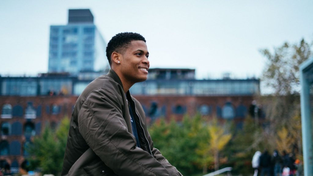 Enjoying the Brooklyn Bridge Park views in an olive bomber jacket.