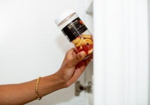 Shot by Curious Lens, model Tyler Jurelle presents a Physicians Grade CBD gummies bottle, showcasing the product’s features.