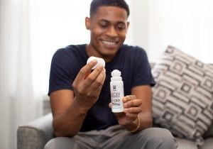 Tyler Jurelle shows Physicians Grade CBD balm, with his face and hands in focus, highlighting its benefits. Check out his content marketing work.