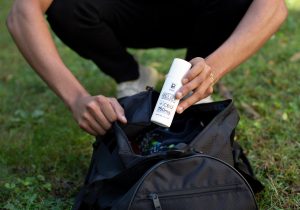 Close-up of hands holding a Physicians Grade CBD balm jar, highlighting its premium packaging.