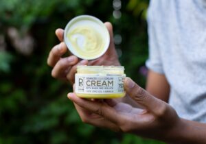 Tyler Jurelle holding a container of The Advanced Relief Cooling Cream with Pure CBD Isolate, sold by Physicians Grade.
