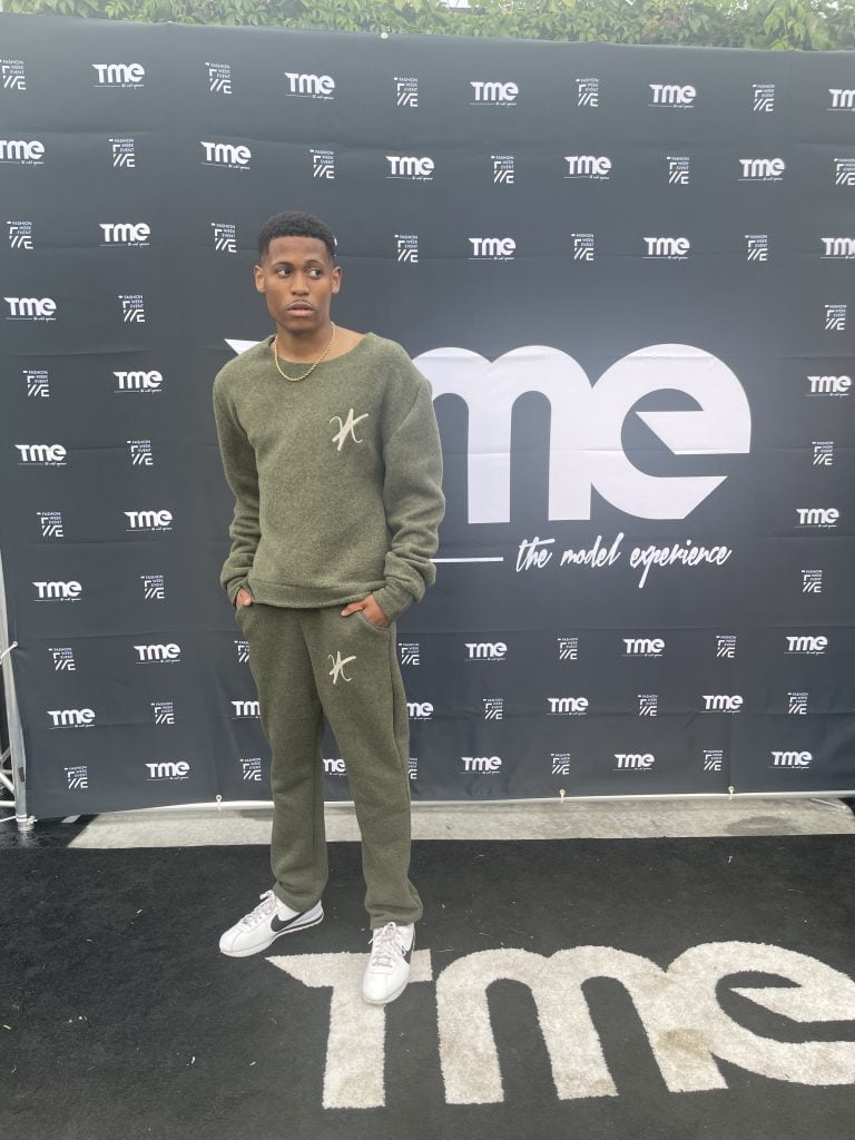 Moments before hitting the runway, Tyler is styled in a khaki green wool set for New York Fashion Week.