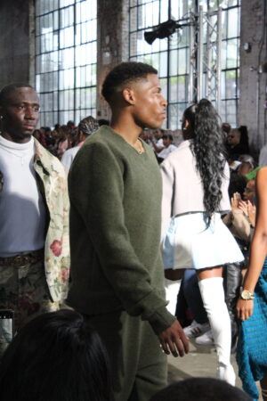 Leading the runway with confidence and style in Vaughn Acquis’s wool crewneck set.