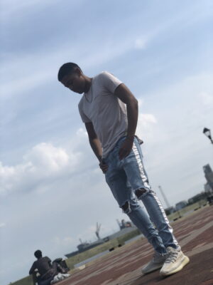 Tyler Jurelle wearing the Distressed Track Denim - Light Stone, from Lakenzie, now known as Reputation Studios.