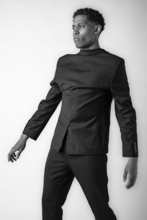 A black-and-white take on a bold fashion statement by Tyler Jurelle, with the blazer worn backward.