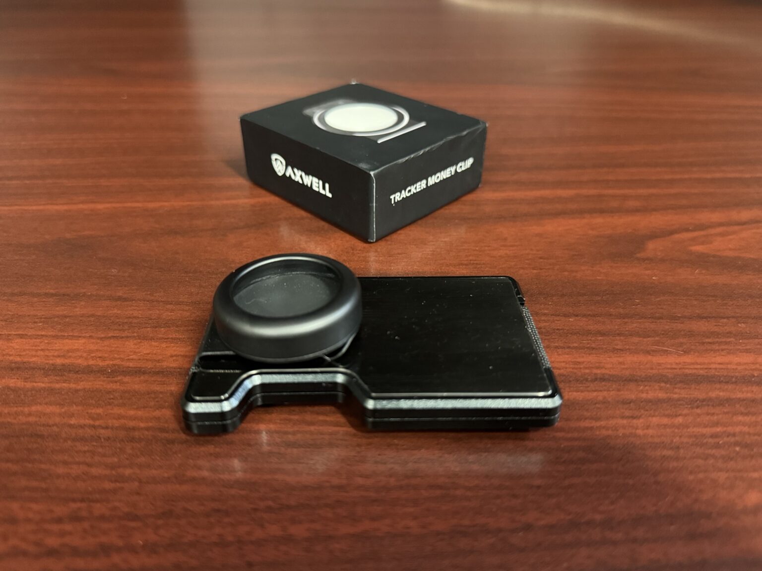 Axwell's AirTag Money Clip attached to the Black Damascus wallet.