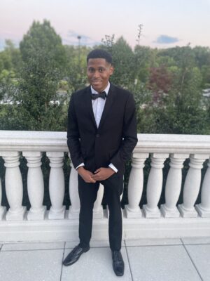 Tyler Jurelle exudes sophistication in a full suit and bow tie at the event.