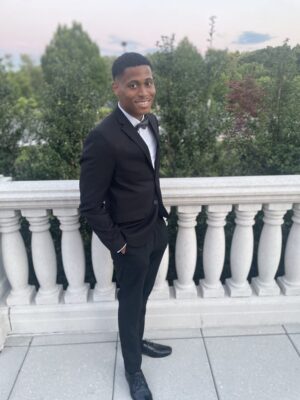 At the event, Tyler Jurelle presents a classic style with a sharp suit and bow tie.