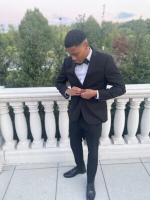 Dressed in sophisticated evening attire, Tyler Jurelle wears a suit and bow tie to the event.