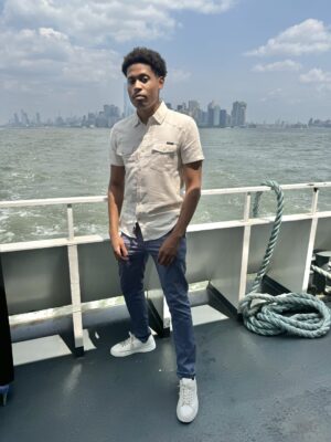 Tyler Jurelle sails toward the iconic New York City skyline, blending the tranquility of the harbor with the city’s energy.
