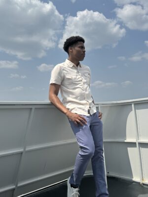 Tyler Jurelle gazes thoughtfully across the water, reflecting on the serene beauty of the New York City Harbor.